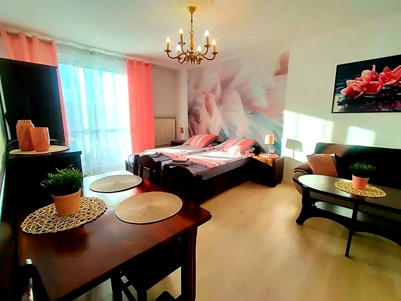Apartament z charakterem Fine Stay - sypialnia z fototapetą we flamingi, żyrandolem i koralowymi dodatkami